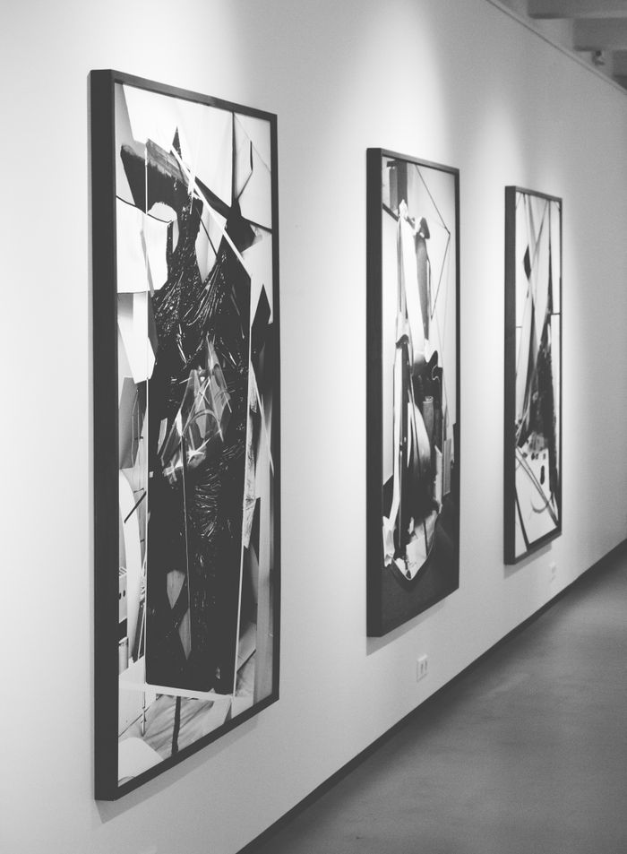 Offerings Monochrome abstract paintings on display in a modern art gallery.